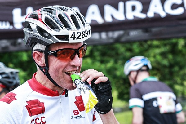 A keen cyclists recharging his energy stores with a energy bar